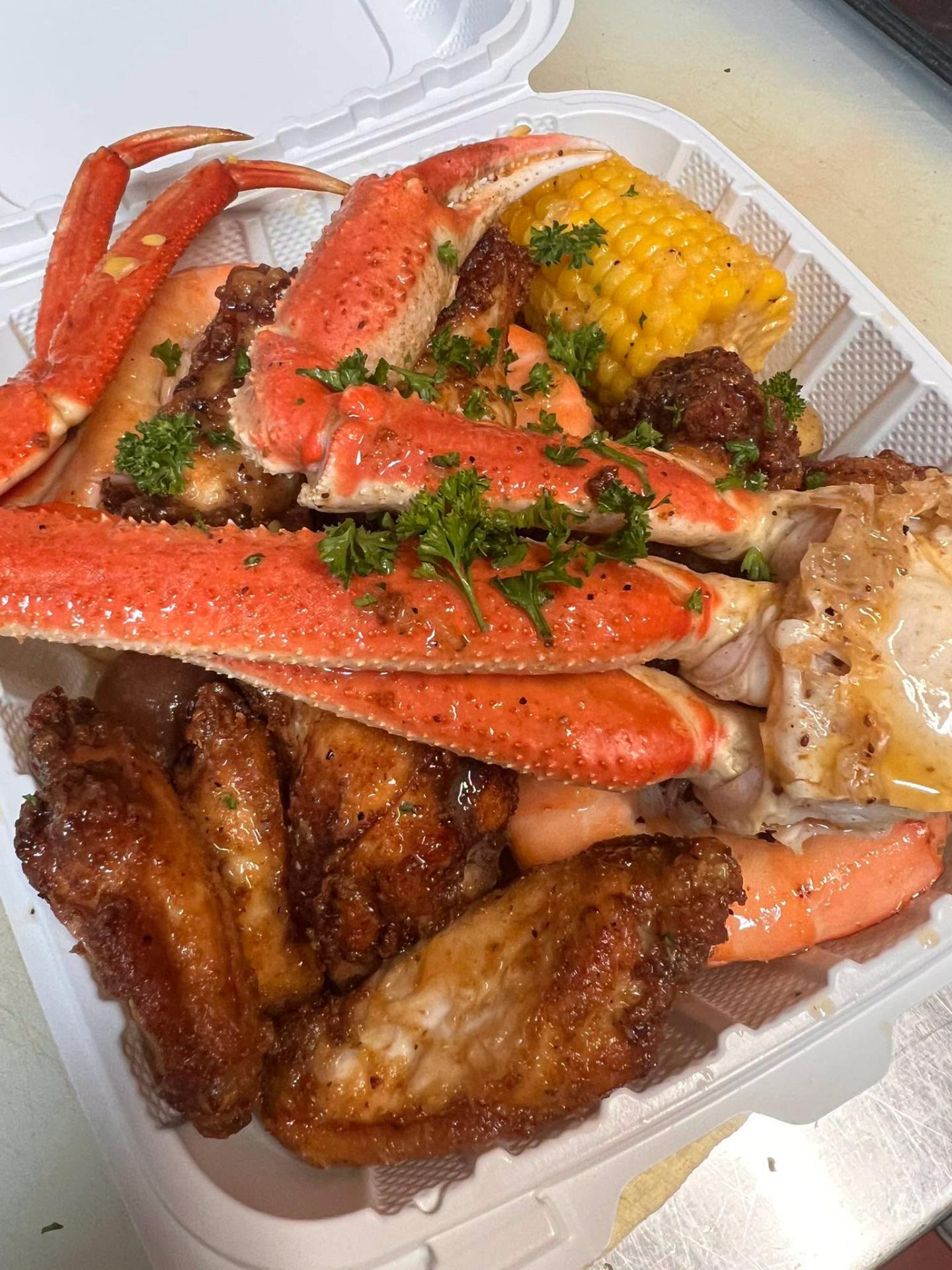 Snow crab legs with wings and corn