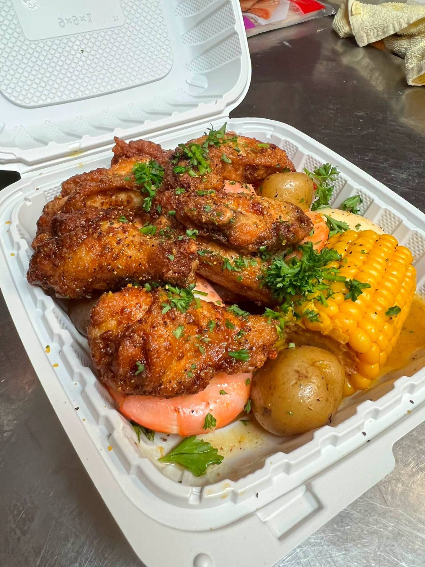 Cajun fried wings with corn and potato